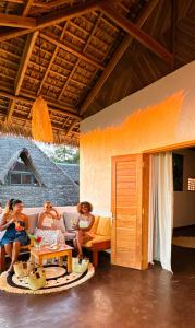 a group of women sitting on a couch in a room at Mahé Lodge, Nosy Be in Nosy Be