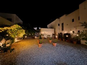a courtyard at night with lights and potted plants at Supreme Comfort In Skala in Skala +4 photos