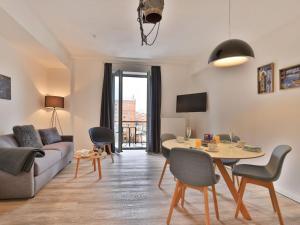 a living room with a couch and a table at Ohlerich Speicher App_ 08 in Wismar +21 photos