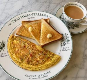 two pieces of toast on a plate with a cup of coffee at Hotel Aura Bellamonts Near Delhi Airport- Free Airport PickUp & Drop , Breakfast & Dinner Complementary in New Delhi