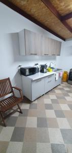 a kitchen with a counter and a chair in a room at Casa Ghemus Costinesti in Costinesti