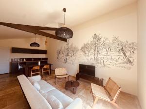 a living room with a couch and a piano at Le Chai de Canteloup in Yvrac