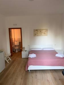 a bedroom with a large bed with a pink blanket at Dal barone in Capo dʼOrlando