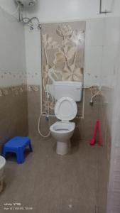 a bathroom with a toilet and a blue stool at SD Residency - Yercaud in Yercaud