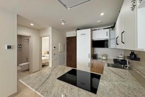 a kitchen with white cabinets and a counter top at Antika Marbella 1A in Marbella
