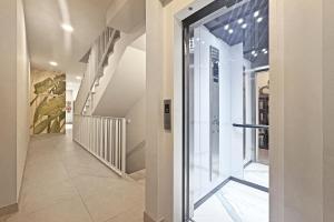 a hallway with a glass door in a building at Antika Marbella 1A in Marbella