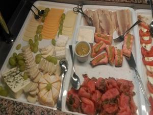 a tray filled with different types of cheese and meats at Landhaus Sundern in Tecklenburg