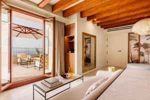 a living room with a couch and a table at Gran Hotel Margalida by Annua Signature in Banyalbufar +94 photos