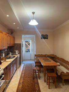 a kitchen with a wooden table and a dining room at Sielski domek w Orawce in Jabłonka