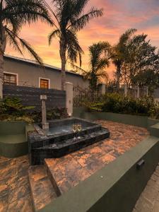 a couple of wine glasses sitting on a stone bench at Mount Glow Self-Catering in Swellendam