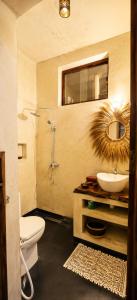 a bathroom with a sink and a toilet and a mirror at BamBam Bungalows Zanzibar in Nungwi +47 photos