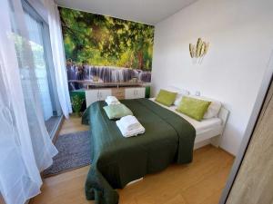 a bedroom with a bed with a painting on the wall at Dream Getaway Apartment with Jacuzzi and Pool in Vienna