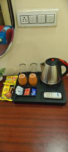 a tray with a tea kettle on a table at The duggar villa in Jammu