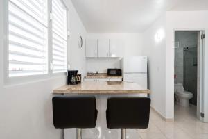 a kitchen with a counter and a refrigerator at Colmado by Otium in Hato Candal