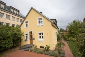 a yellow house with a pathway in front of it at finkeshaus in Lüdinghausen