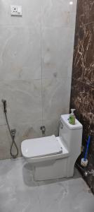 a bathroom with a white toilet in a room at The duggar villa in Jammu