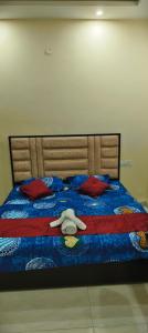 a bed with a stuffed animal laying on it at The duggar villa in Jammu