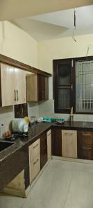 a kitchen with wooden cabinets and a counter top at The duggar villa in Jammu +9 photos