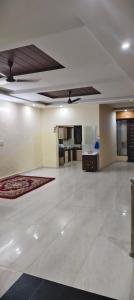 a large living room with a white floor and ceiling at The duggar villa in Jammu