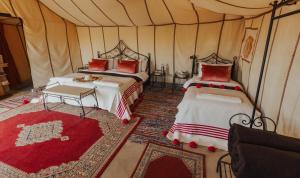 a bedroom with two beds in a tent at Kidal Luxury Camp in Adrouine