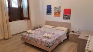 a bedroom with a bed with shoes on it at La casa rossa in Siderno Marina