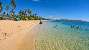 a group of people in the water at the beach at Casita Velera in Lajas