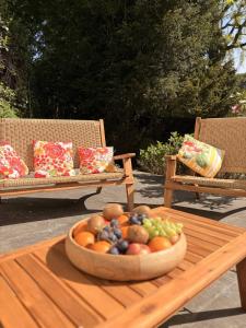 a bowl of fruit on a table with two chairs at Chateau entierement privatise in Hannut