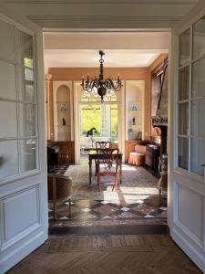 a dining room with a table and a chandelier at Chateau entierement privatise in Hannut +96 photos