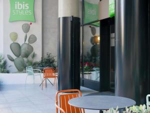 a cafe with tables and chairs in a building at ibis Styles ST Pauls Bay Malta in St. Paul's Bay