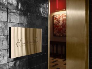 a sign on the wall of a hotel lobby at Hotel Morris Sydney, Handwritten Collection in Sydney