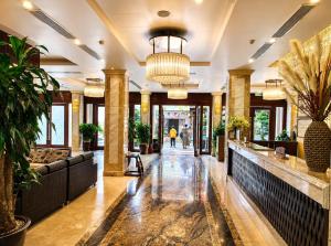 a lobby of a hotel with a potted plant at Canvas Sapa Legend Hotel in Sapa
