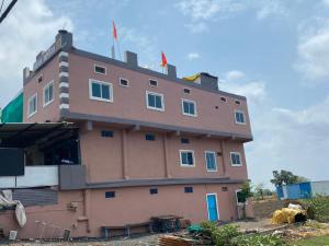 a building with a house on the top of it at Hotel Arpita in Ashta