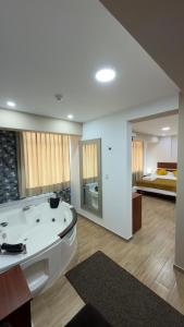 a large bathroom with a tub and a bed at Hotel Residencial Paris in Arequipa