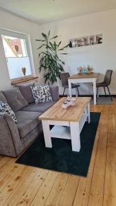 a living room with a couch and a coffee table at Pension Fiete Celle in Celle