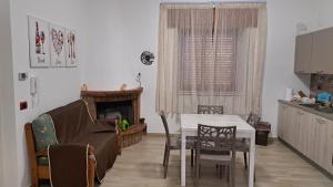 a living room with a couch and a table at La casa rossa in Siderno Marina