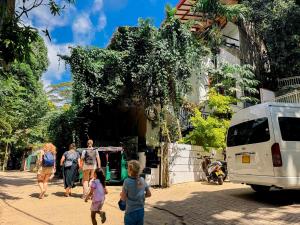 a group of people walking down a street with a van at Lava Ella in Ella