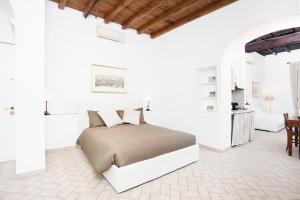 a bedroom with a large bed in a white room at Tritone 91 Apartments in Rome