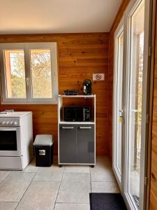 a kitchen with a stove and a microwave at Charmant chalet en montagne in Petreto-Bicchisano