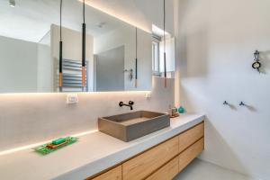 a bathroom with a sink and a mirror at Villa Ena - Beach getaway in Logaras +14 photos