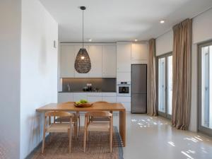 a kitchen with a dining room table and chairs at Villa Ena - Beach getaway in Logaras