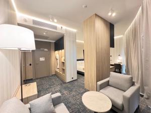 a room with a couch and a chair and a table at West Plaza Hotel in Oral +50 photos