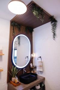 a bathroom with a black sink and a mirror at 6BR Beachfront Compound w-Generator & Games in Camuy +40 photos