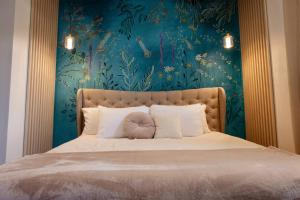 a bedroom with a large bed with a blue wall at 6BR Beachfront Compound w-Generator & Games in Camuy
