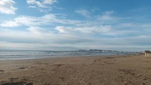 a sandy beach with waves in the ocean at APP Apartament in Durrës +10 photos