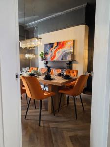 a dining room with a table and chairs at Fox House Llandudno in Llandudno
