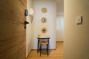 a small table with a stool in a hallway at Studio S Les Suites Du Roubion in Montélimar