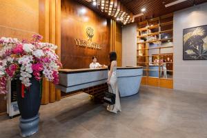 a woman standing in front of a tub in a store at Yes Hotel Đà Nẵng in Danang