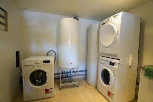 a laundry room with a washing machine and a washer at Studio S Les Suites Du Roubion in Montélimar
