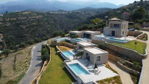 an aerial view of a house with a swimming pool at Alos Suites in Verga Kalamata
