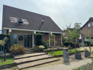 a house with stairs leading to the front door at De kleine Bongerd -The little Orchard in Hengelo